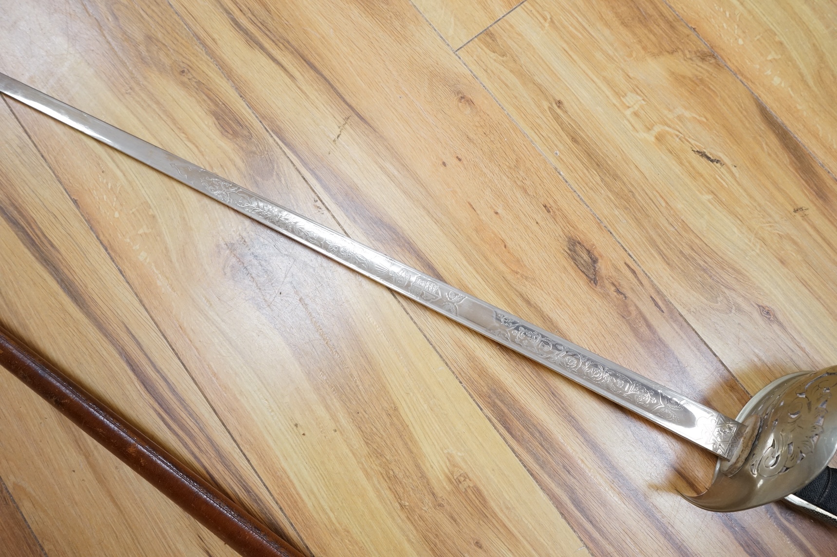 A George V 1897 pattern infantry officer’s sword, with regulation blade etched with the union flowers, Royal Arms and owners name; J.W. Reynolds, Dorrington, Lincoln, regulation nickel guard stamped ‘WH&S’ in minuscules,